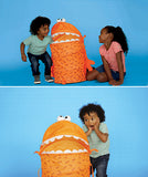 Image of young children playing the game, and the surprised look on their face when the pancake monster pops up to swallow their arm!