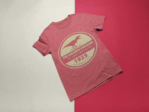 Heather Red tee shirt with round image displaying a T. rex above "The Children's Museum of Indianapolis" and at the bottom "1925 Established".