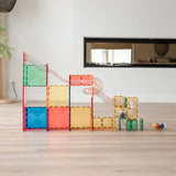 Colorful marble run built on a light wooden floor.