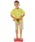 Young child smiling while bouncing on the pogo jumper.