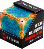 Shashibo in box.  Cutout allows you to see the design on the cube.  The current shape has a blue-green center with red-orange edges, resembling oceans and land.  