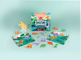 Picture displays the contents of the game surrounding the box.  Dinosaur cutouts are all different color and pattern combinations.  There are scene cards where the 'collected' dinosaurs are placed until a winner has collected them all.