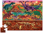 Assembled puzzle, approximately top third of the puzzle is the depiction of many species of dinosaurs around a watering hold. The bottom third is 'underground' and depicts dinosaur skeletal fossils.