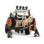 Rear view of the off-road vehicle showing the back gate opens and has a winch on the back as well.  Playful chimpanzee is holding onto the winch hook.  
